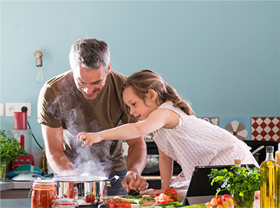 nourish your family, man and young girl cooking together